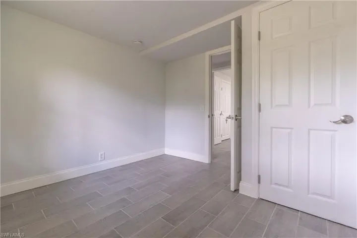 Unfurnished room with dark hardwood / wood-style floors