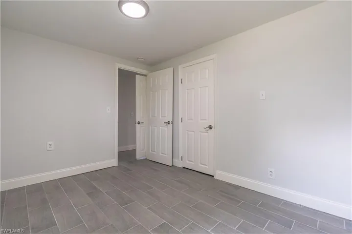 Unfurnished bedroom featuring a closet and light hardwood / wood-style floors