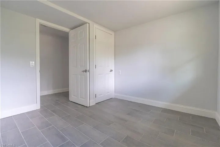 Unfurnished bedroom with light wood-type flooring and a closet
