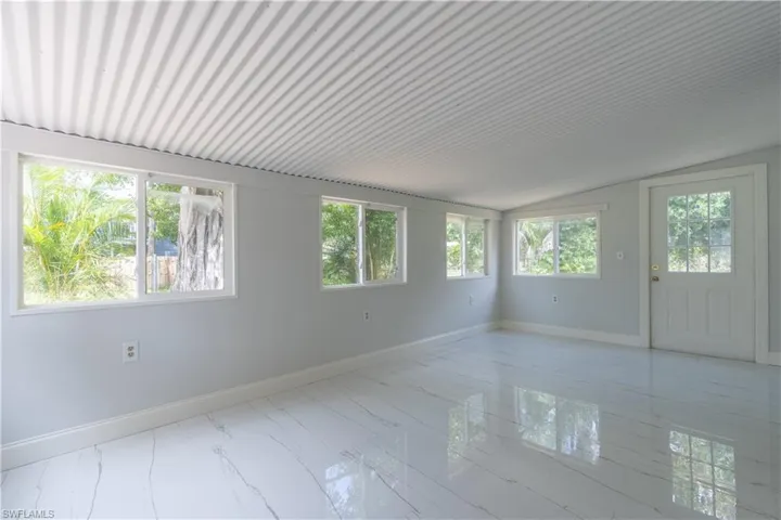 Spare room with lofted ceiling