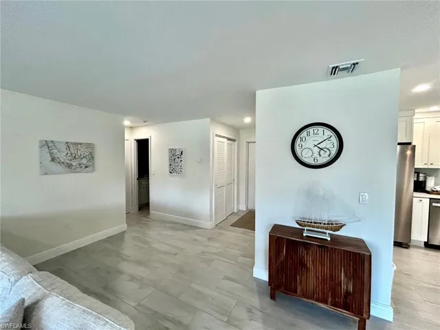 Living area featuring baseboards and recessed lighting