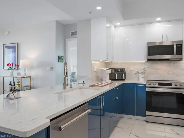 New pantry doors with wood sliding shelves, new fridge and new stove/with glass cooktop