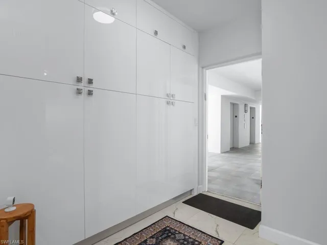 All new custom storage cabinetry just inside the door