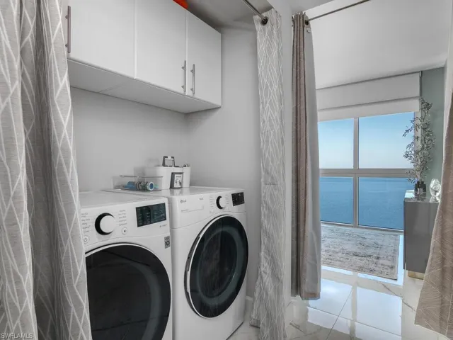 Newer washer and dryer with cabinets installed above