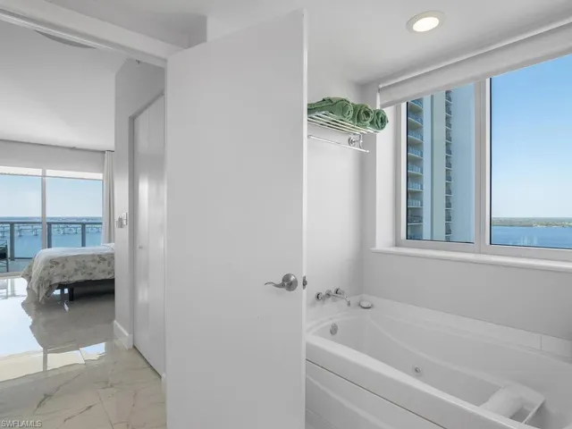 Primary bathroom also with a water views, looking to the primary bedroom to the Western water and sunset views