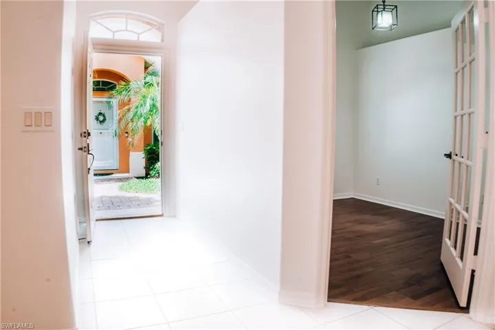 Hall featuring a healthy amount of sunlight and wood-type flooring