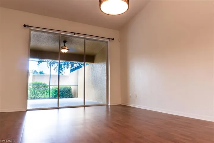 Spare room with vaulted ceiling and hardwood / wood-style flooring