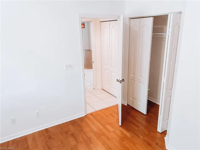 Unfurnished bedroom with light tile floors