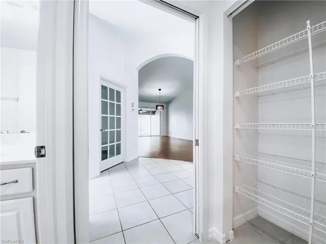 Hallway with light tile floors