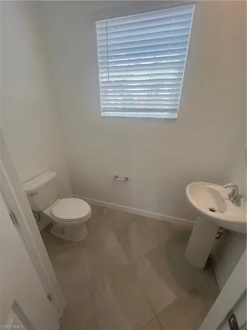 Bathroom featuring tile patterned floors and toilet