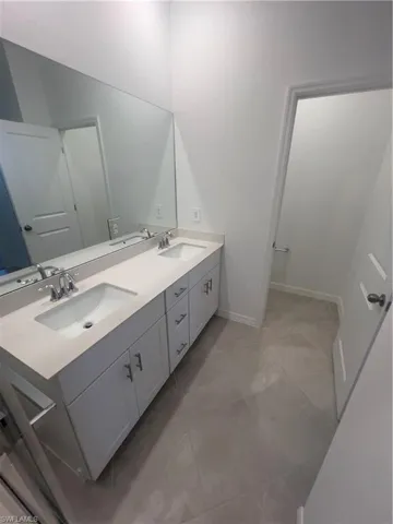 Bathroom featuring tile patterned flooring and vanity
