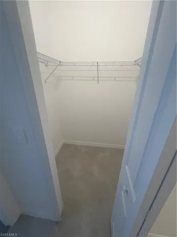 Spacious closet with tile patterned floors