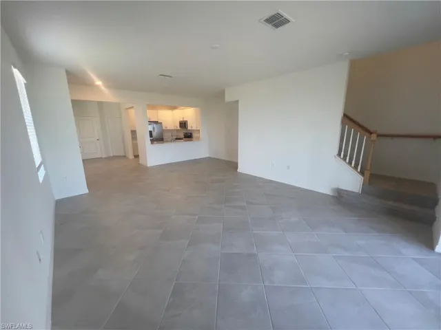 Unfurnished living room featuring tile patterned flooring