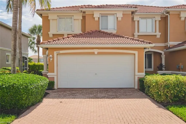 Mediterranean / spanish-style home featuring decorative driveway, stucco siding, a tiled roof, and a garage