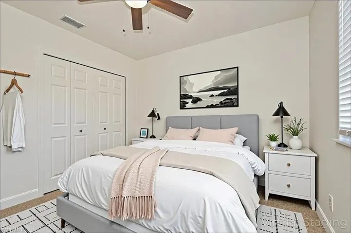 Carpeted bedroom featuring a closet and ceiling fan - virtually staged