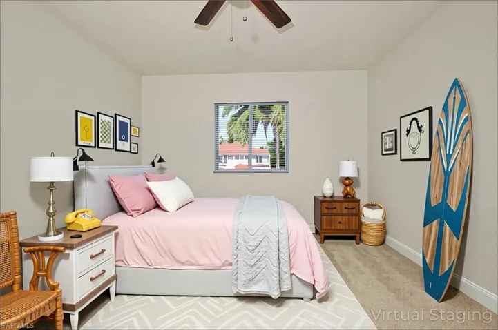 Carpeted bedroom with baseboards and ceiling fan  - virtually staged