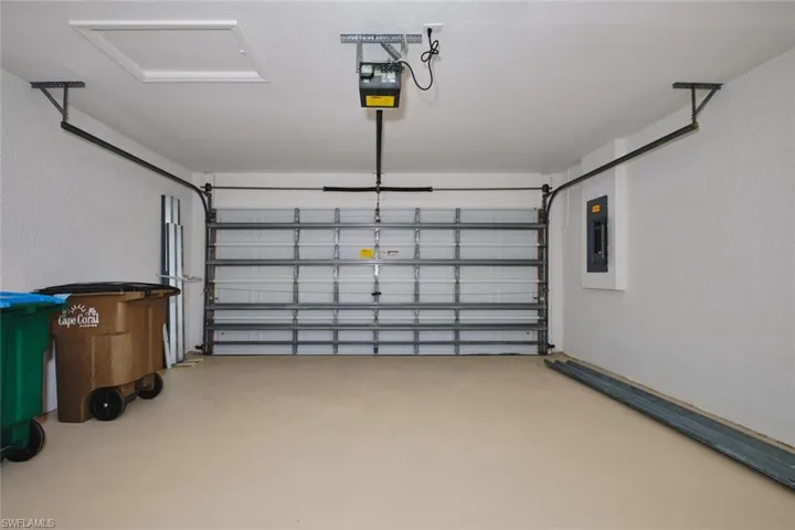 Garage with a garage door opener and electric panel
