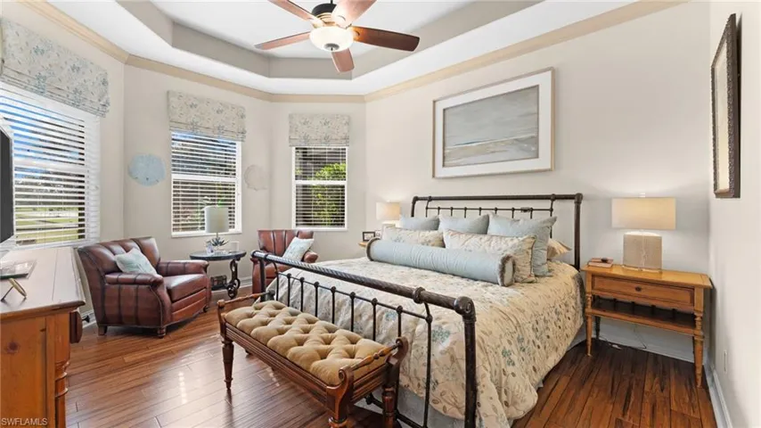 Master Bedroom featuring a tray ceiling, ceiling fan, scraped hardwood / wood-style floors, and ornamental molding