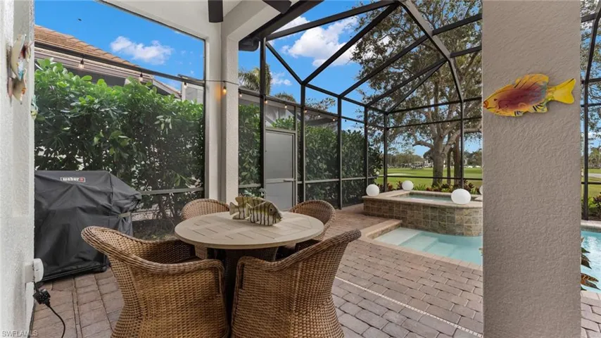 Sunroom / solarium with a swimming pool with hot tub