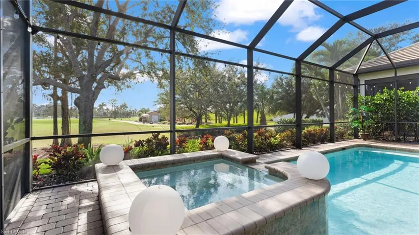 View of swimming pool with glass enclosure