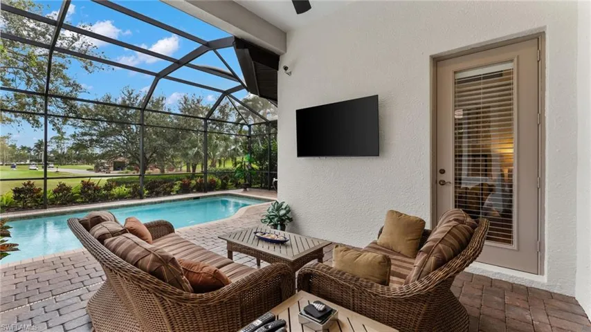 View of pool featuring a patio, an outdoor hangout area, and a lanai