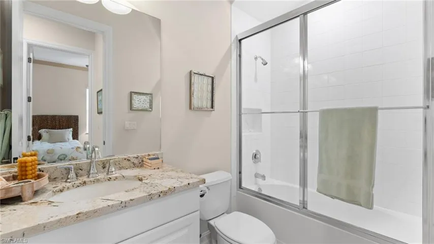 Master Bathroom with tile patterned floors, vanity, and plus walk in shower