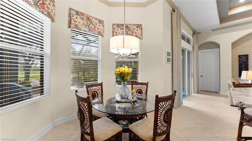 Dining area with an inviting chandelier and ornamental molding
