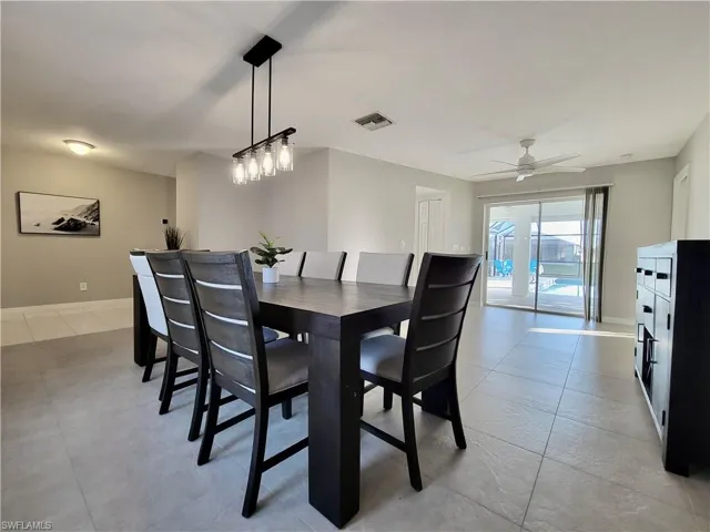 Entry to living area featuring ceiling fan