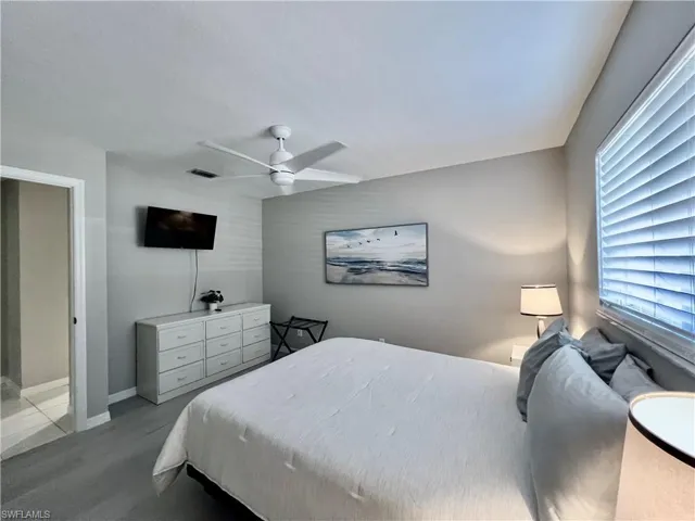 Bedroom 1 with ceiling fan and walk in closet.