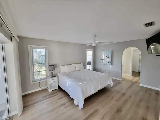 Bedroom with light hardwood / wood-style floors and ceiling fan