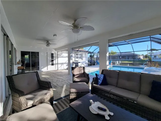Sunroom featuring ceiling fan