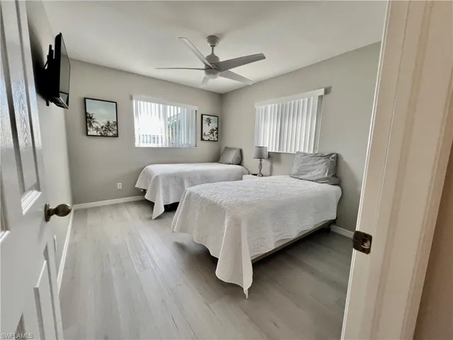 Bedroom 3 featuring walk in like style closet,  ceiling fan and light wood-type flooring