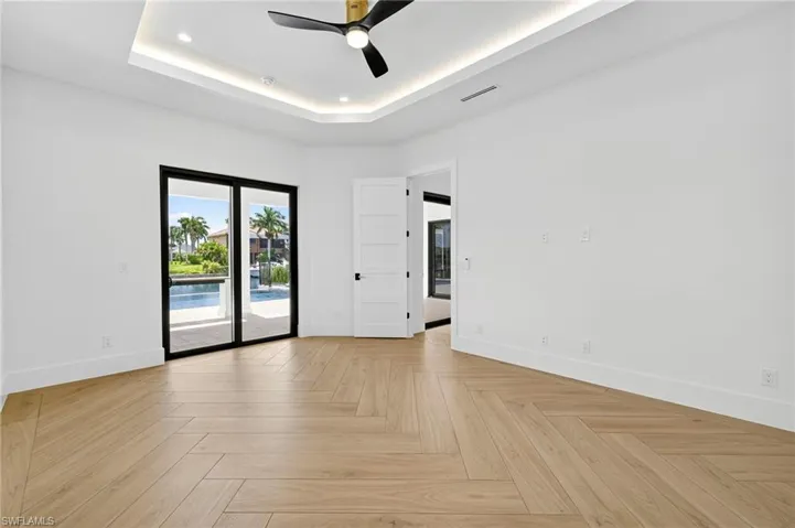 Spare room featuring a ceiling fan and a raised ceiling