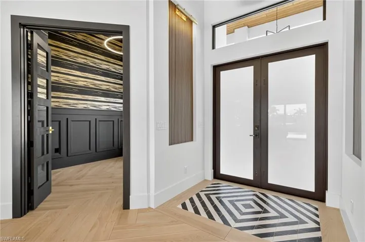 Foyer with french doors and baseboards