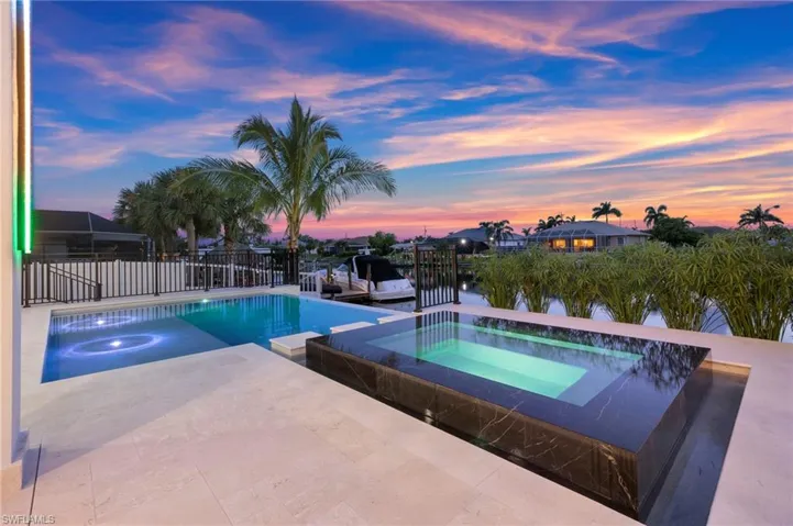 View of pool featuring a patio area and a pool with connected hot tub