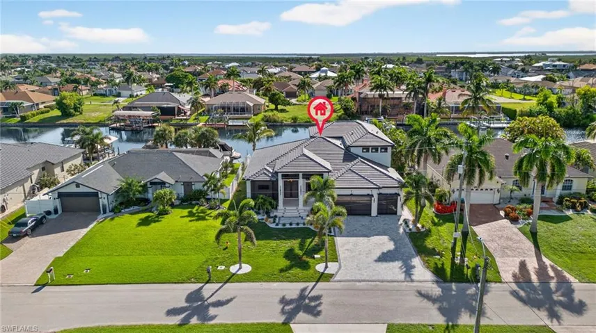 Aerial view of residential area featuring a large body of water