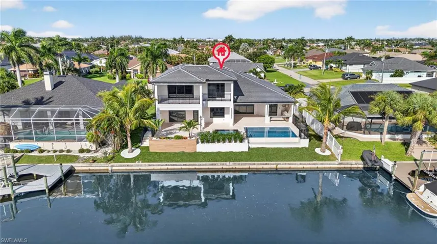 Back of house with an outdoor pool, a patio area, a residential view, a fenced backyard, and a sunroom