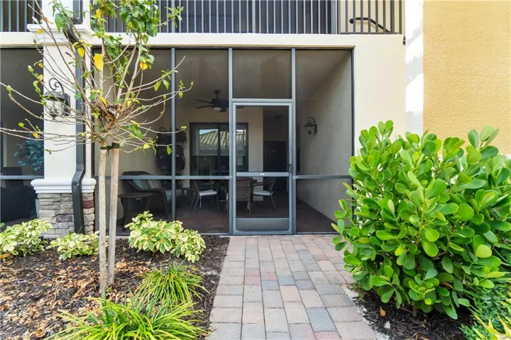 Doorway to property with ceiling fan