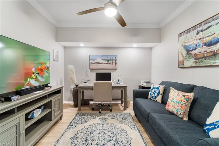 Office featuring ornamental molding, ceiling fan, and light hardwood / wood-style flooring