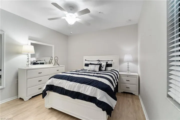 Bedroom with ceiling fan and light wood-type flooring