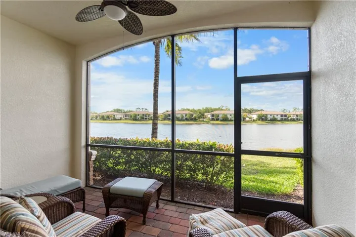 Sunroom with a water view and ceiling fan