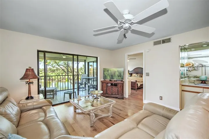 Living room featuring ceiling fan and light wood-type flooring