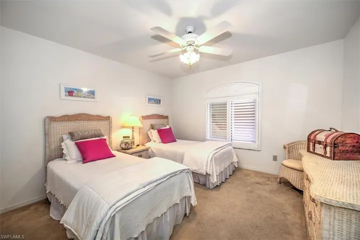 Carpeted bedroom with ceiling fan