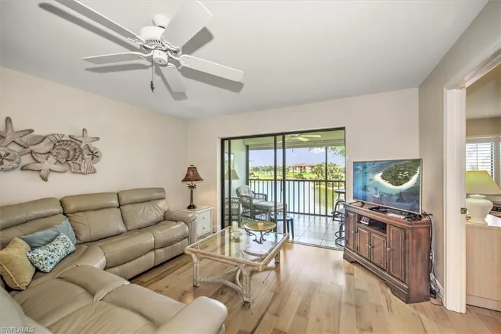 Living room featuring ceiling fan and light hardwood / wood-style flooring