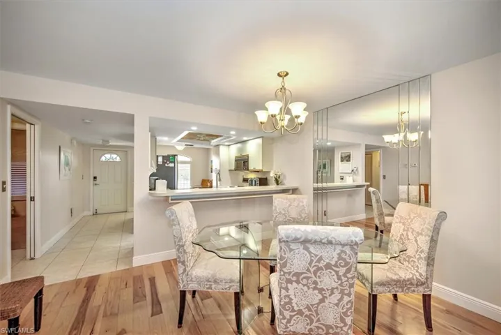 Dining area with a chandelier and light wood-type flooring