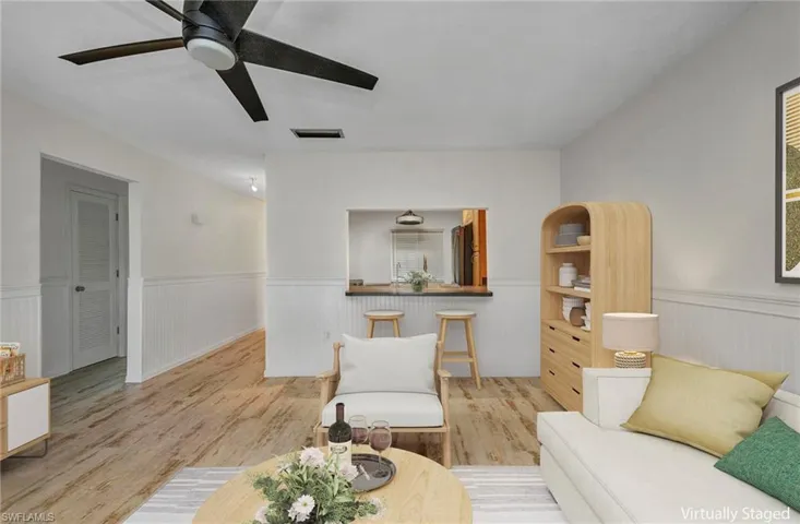 VIRTUALLY STAGED Living room with breakfast bar and kitchen access