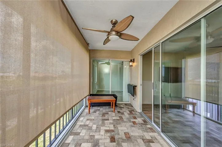 Brick tiled Lanai with sun shade and accordion shutters