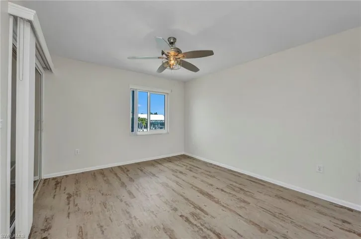 Unfurnished bedroom with ceiling fan, light wood-style floors, and a closet