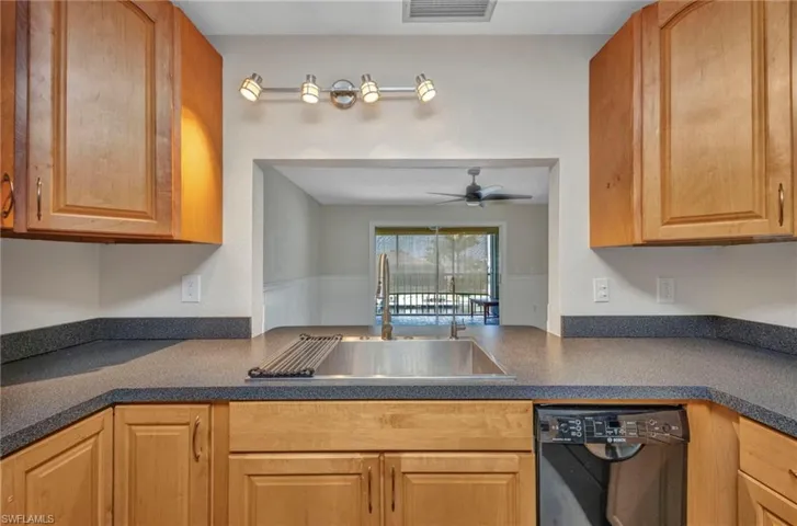 Waterview from the kitchen with stainless steel farm sink and maple wood cabinets