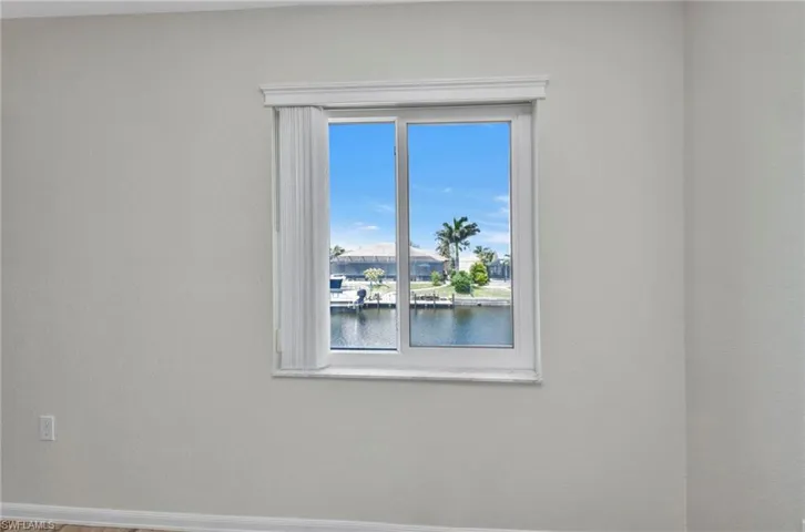 Empty room with a water view and a textured wall